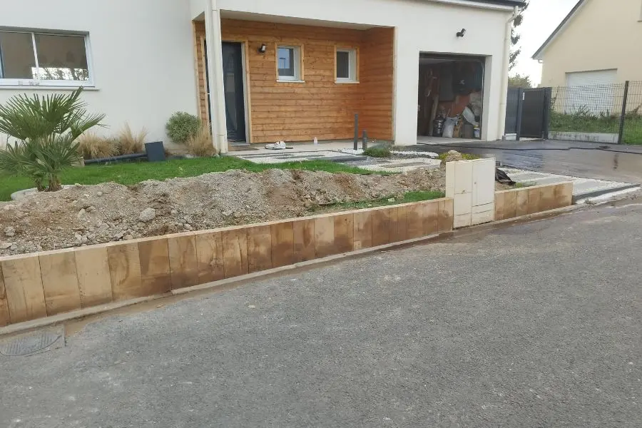 Muret en bois terminé devant la maison, coffret technique intégré